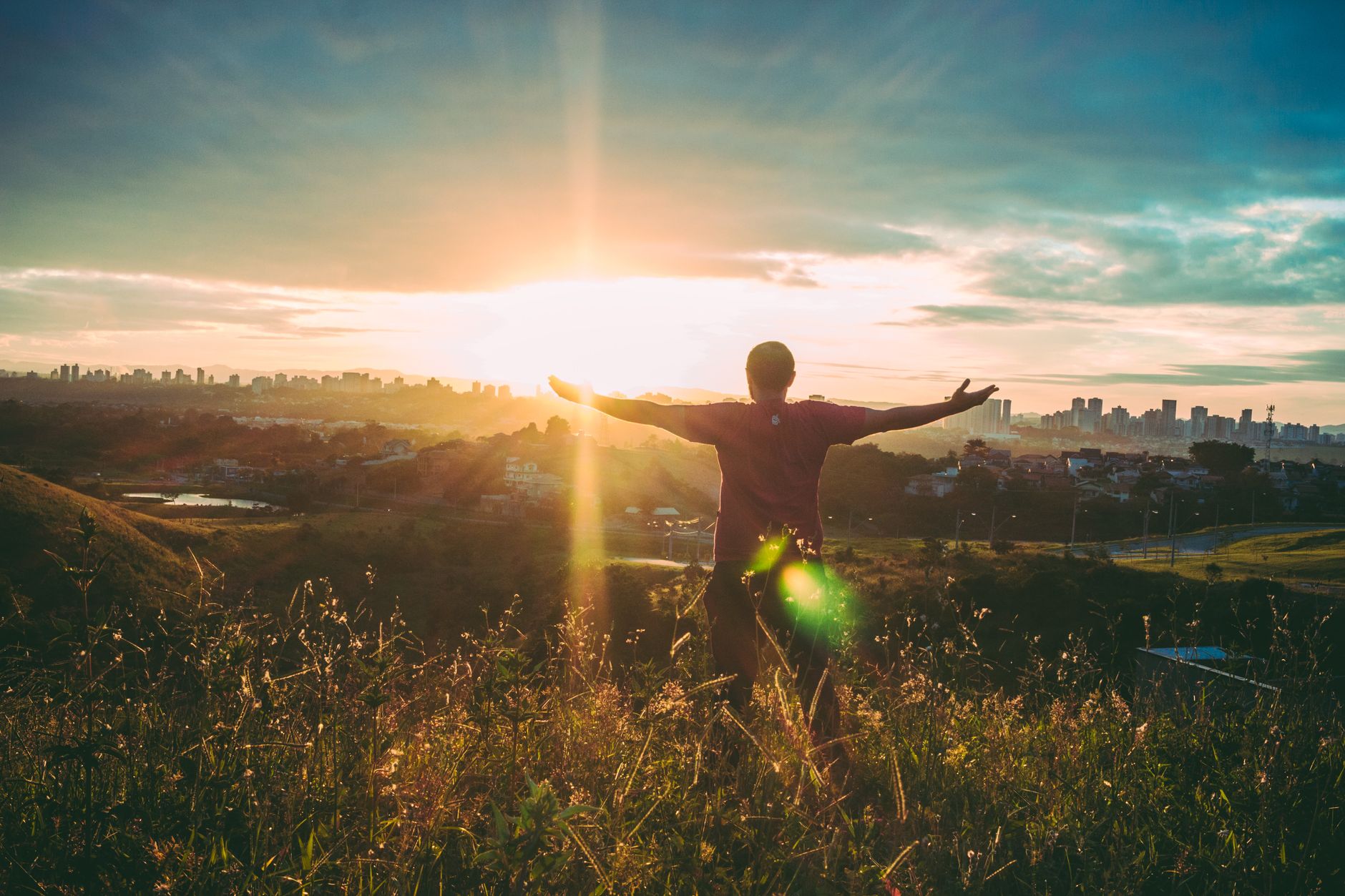 person spreading hands against sun