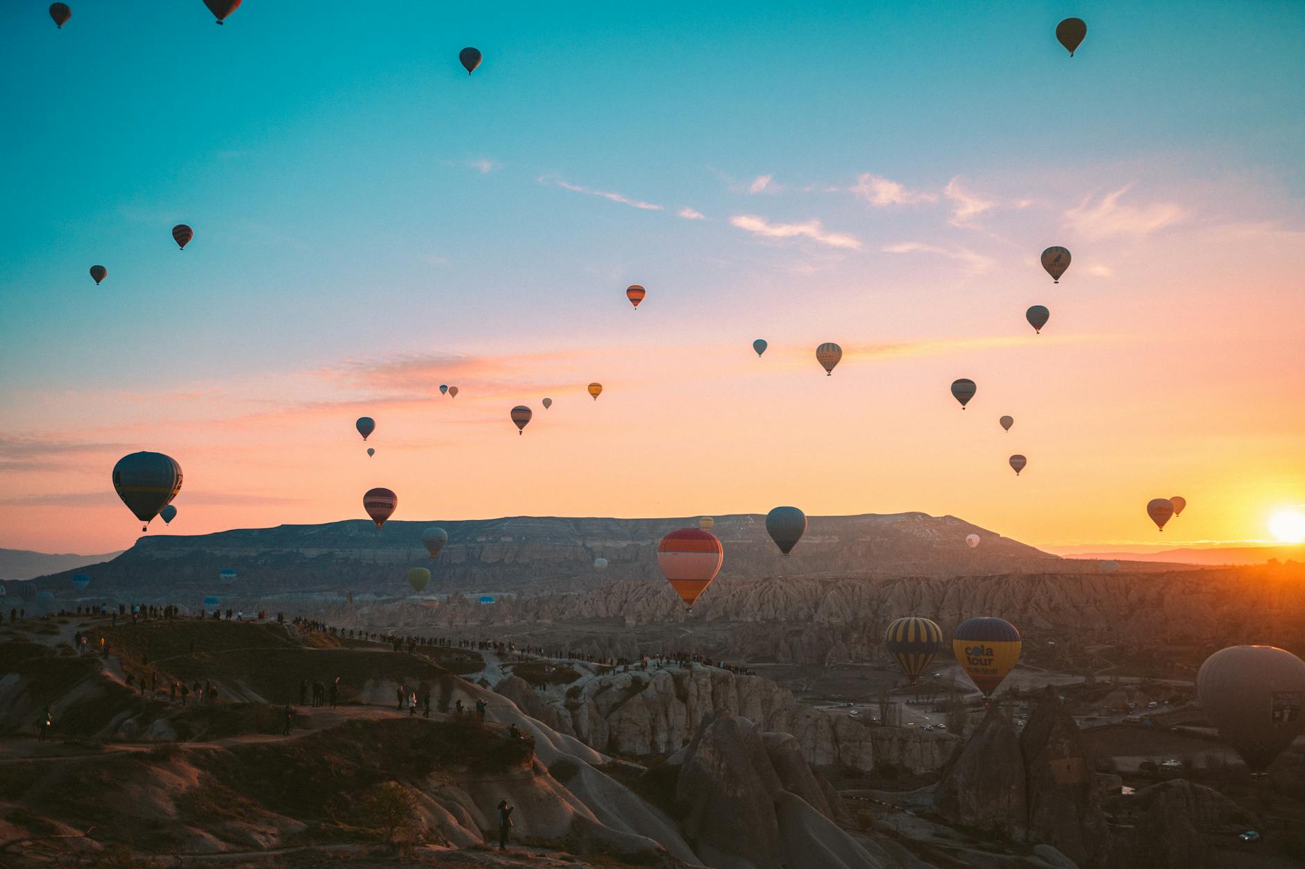 hot air balloons flying over the mountains